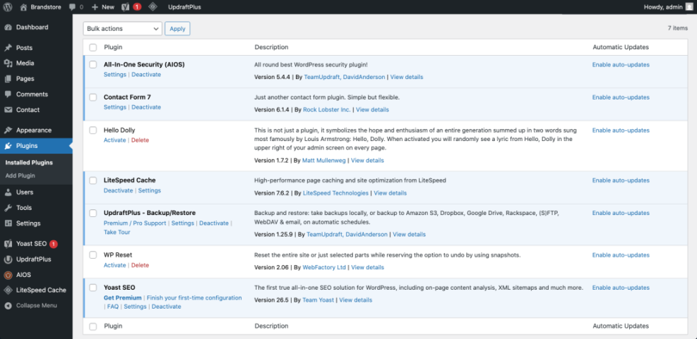 WordPress admin dashboard showing installed plugins essential for building a functional website, like Yoast SEO and UpdraftPlus.